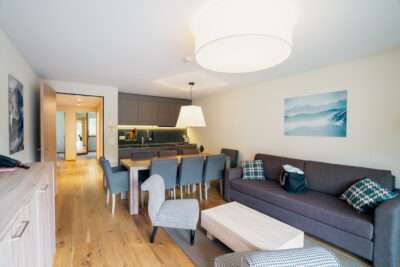 An example of how the living room of an apartment in Peaks Place Laax looks like