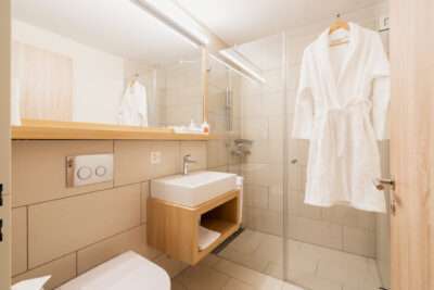 Das moderne Badezimmer mit Dusche im Apartment Hotel Peaks Place in Laax