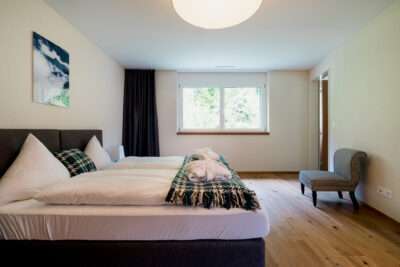 One bedroom of the 4.5 room apartment at Peaks Place Hotel Laax